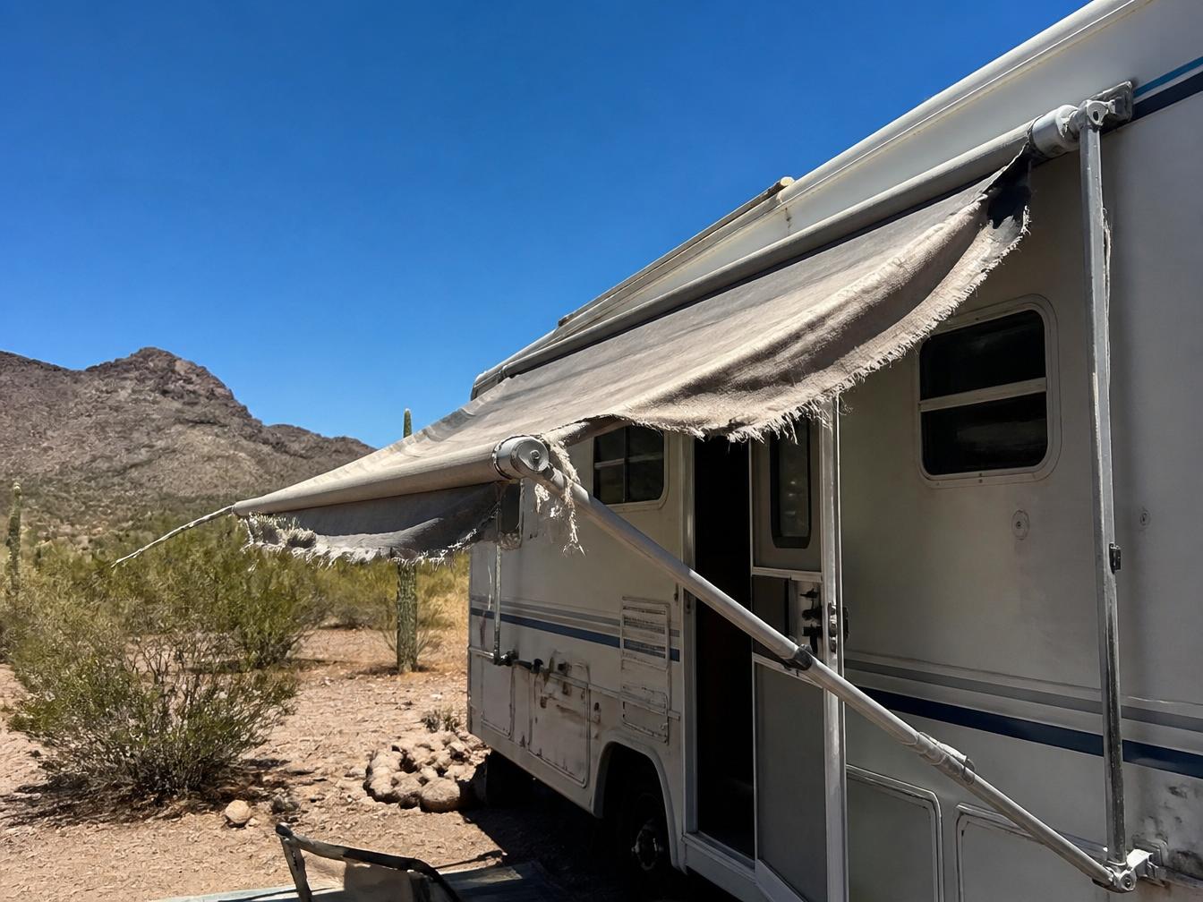 RV awning torn and faded from years of Arizona sun damage