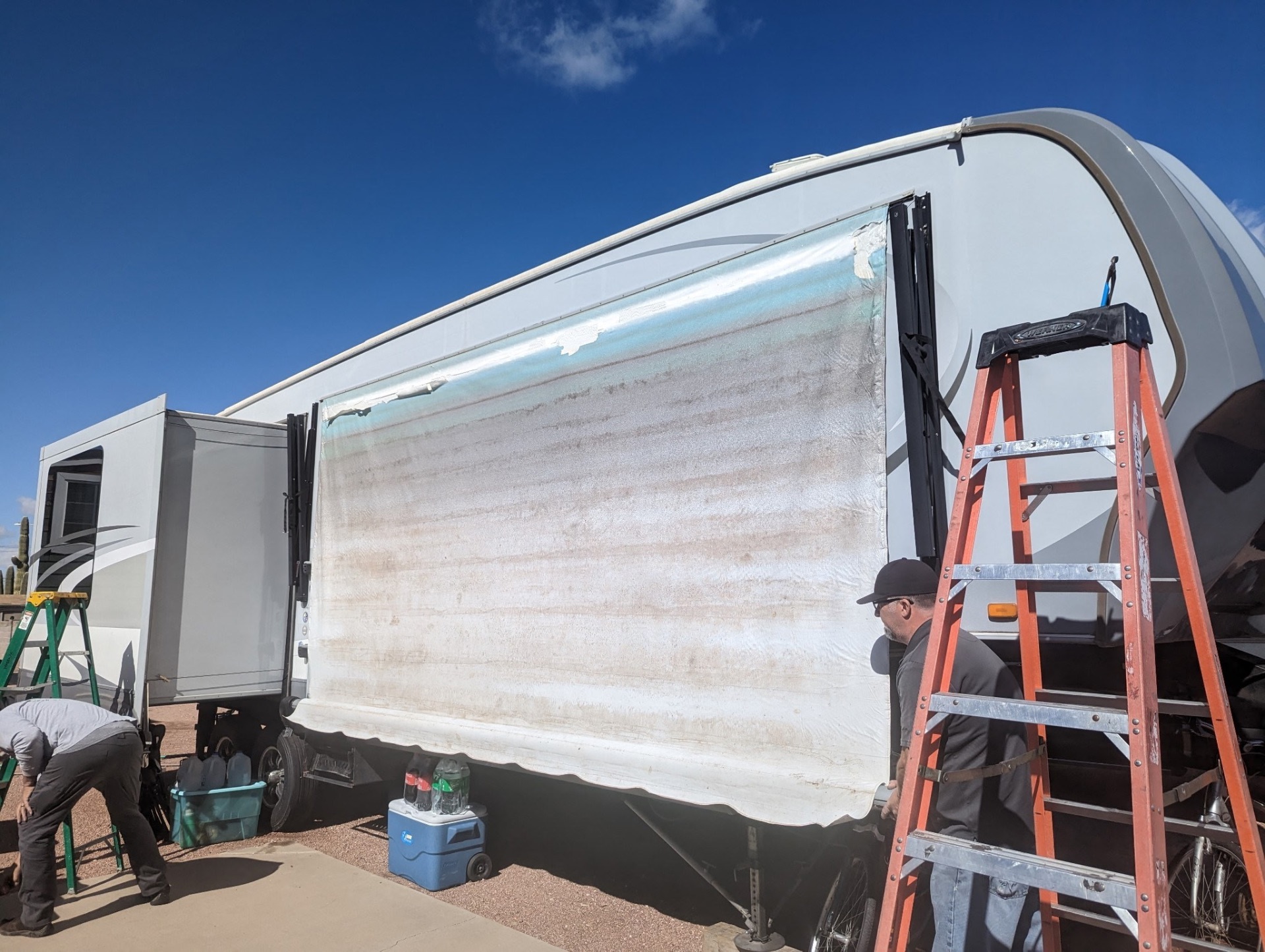 Faded, sun-damaged RV awning fabric before repair